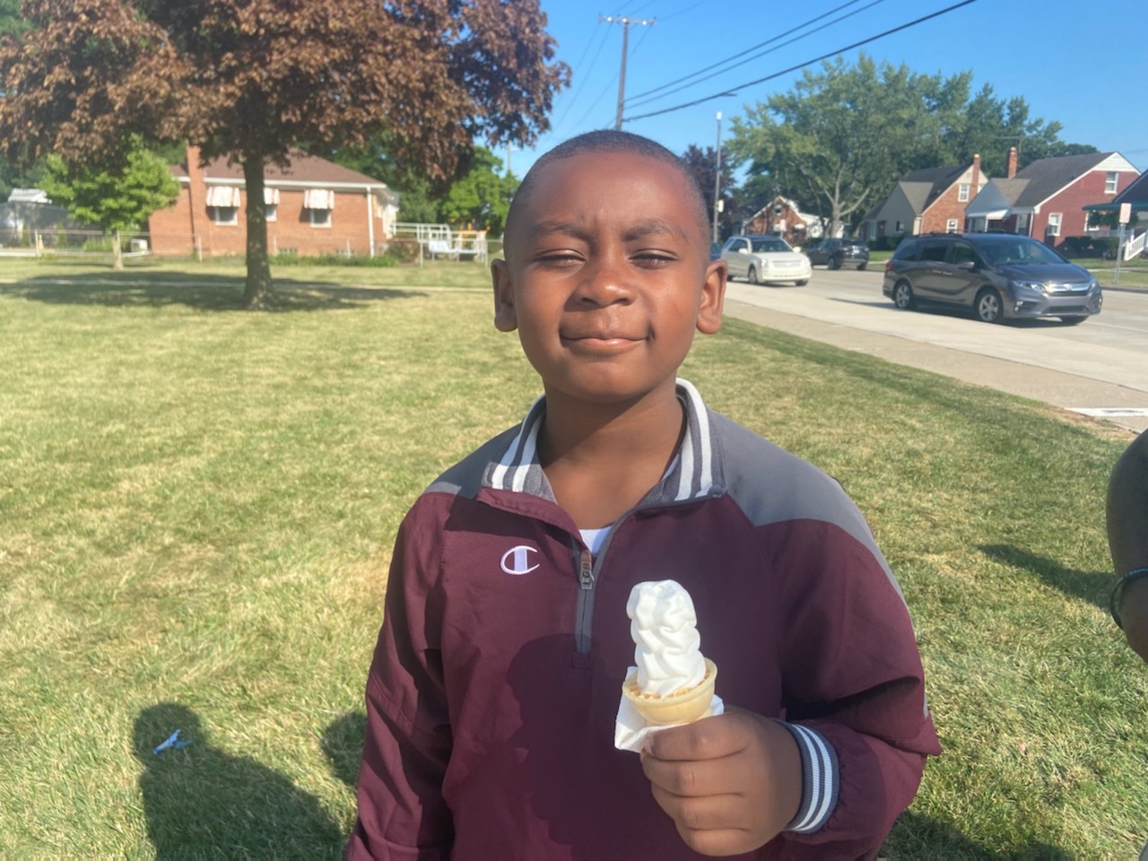 Pleasantview student smiles while holding ice cream cone