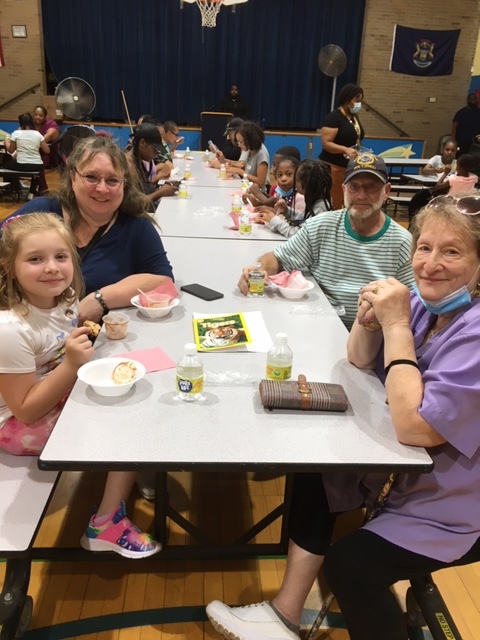 Bellview family smiles while eating in the cafeteria