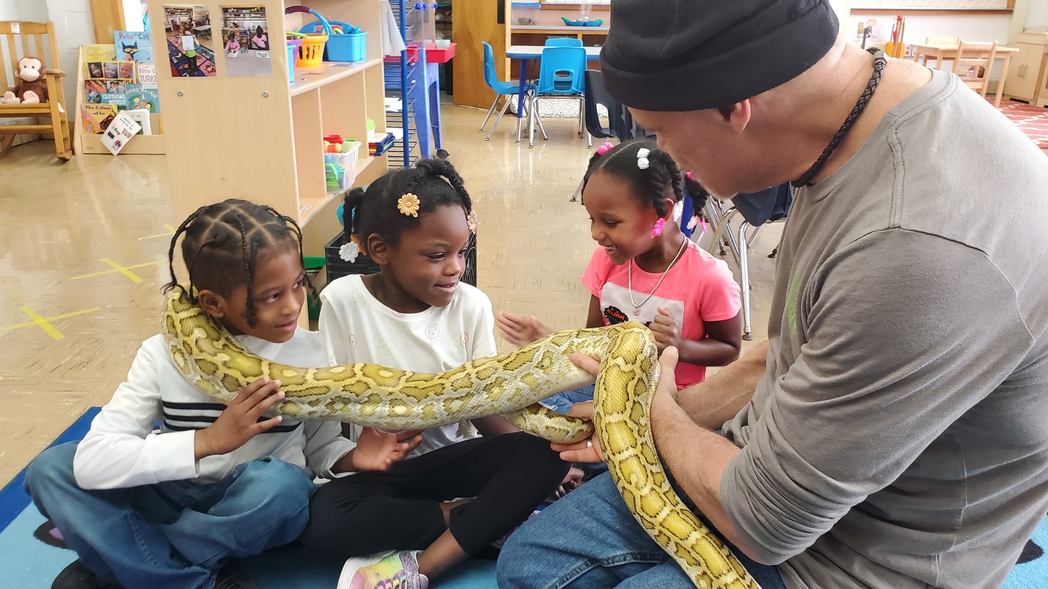 Preschool students with a giant snake