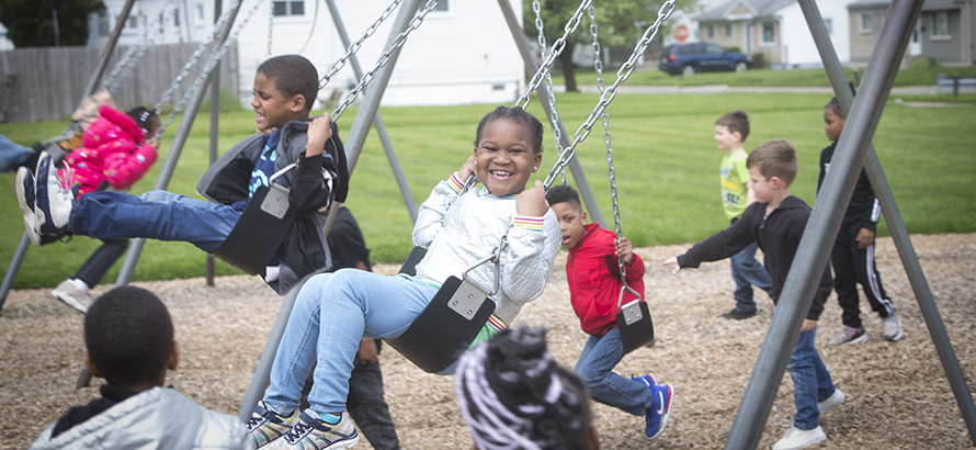 Kindergarten students on swings